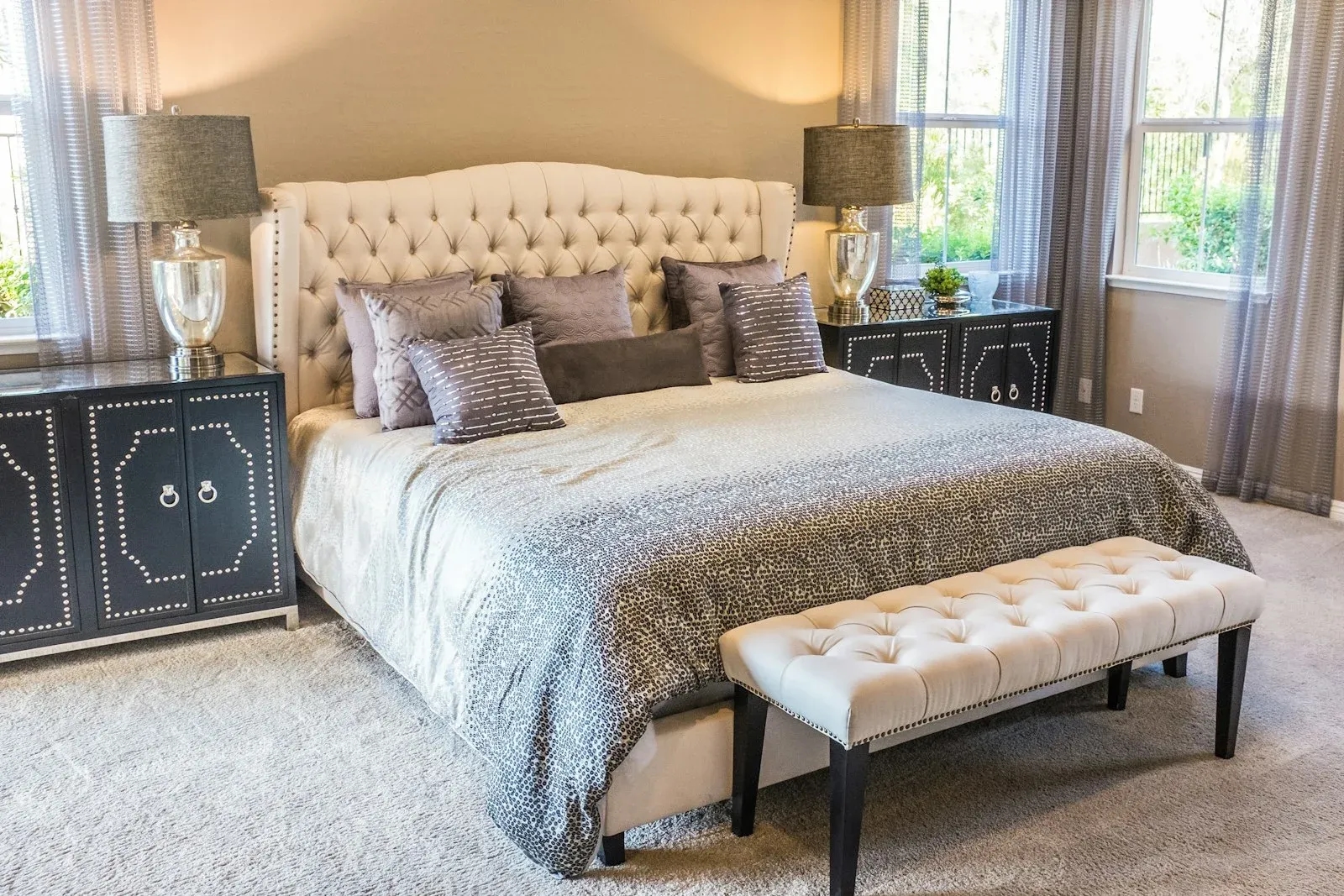Upholstered bed and headboard in a calm bedroom with neutral fabric
