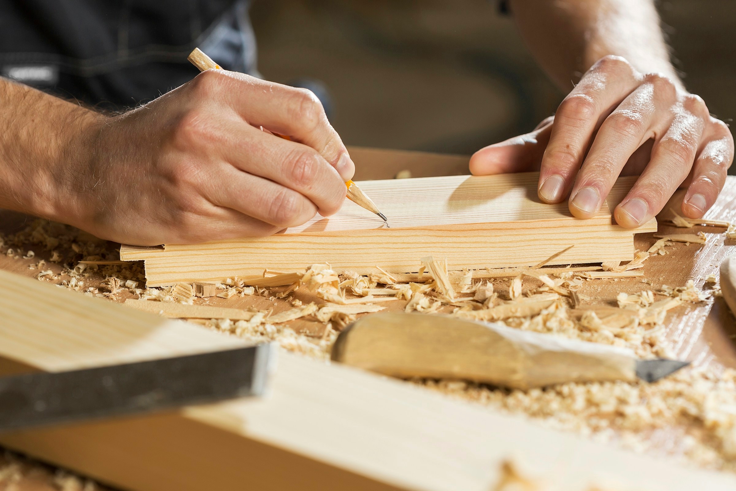 Craftsman shaping solid timber on a workbench